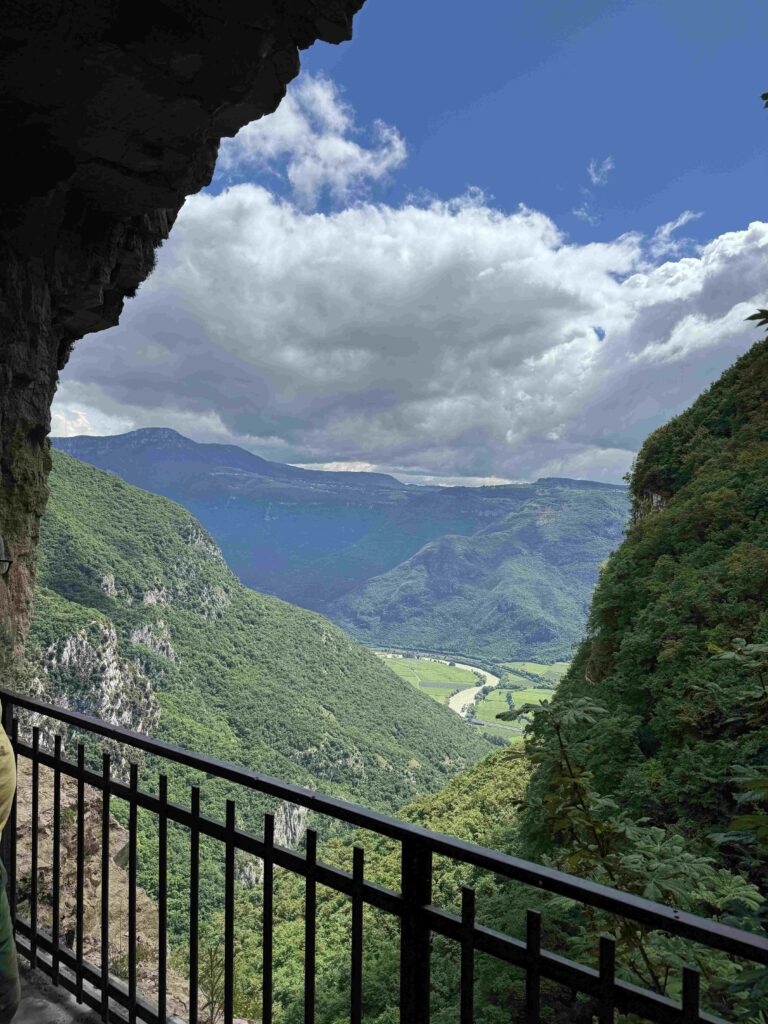 Uitzichtover adige gebergte tijdens de wandeltocht naar madonna della corona. Over het hekwerk kijk je naar het dal onder je